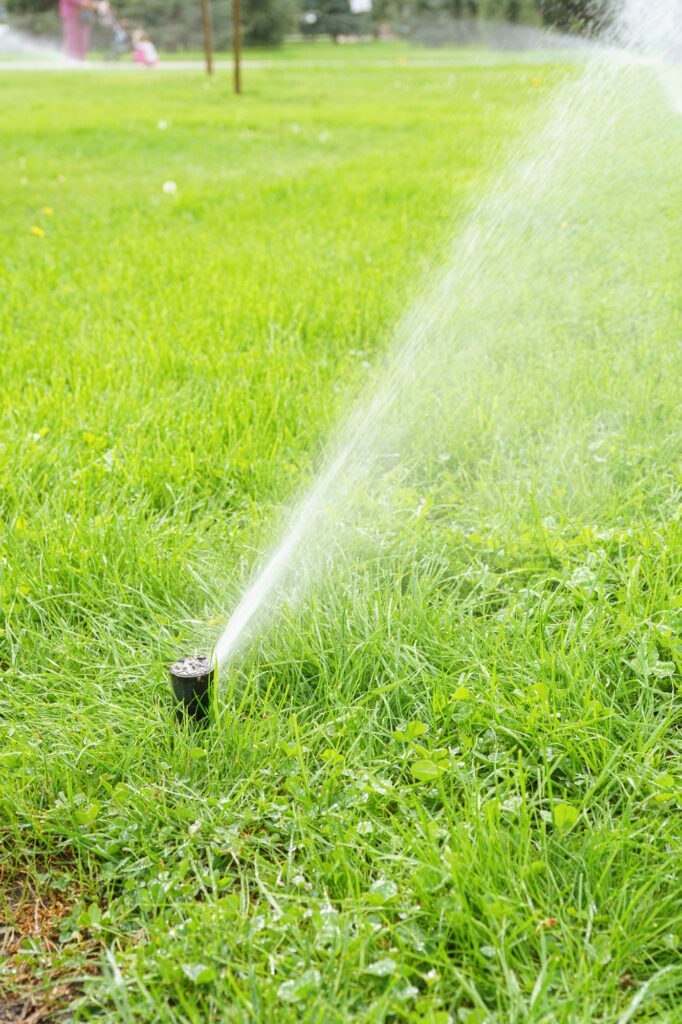 Automatic Smart Lawn Sprinkler With Adjustable Head Watering Green Lawn Grass In Sunny Day
